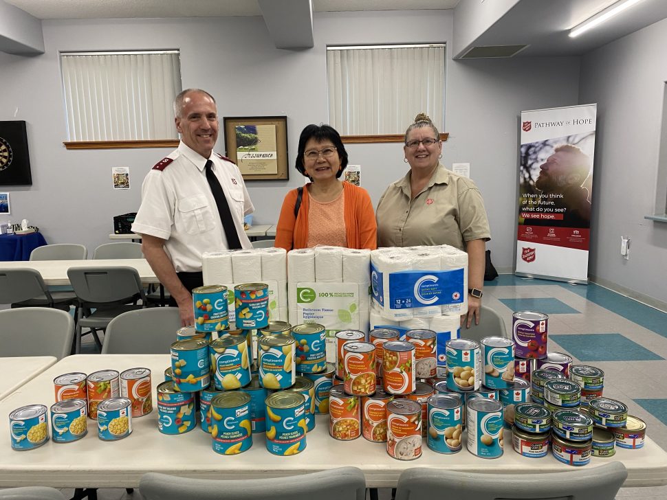 Captain Brain Bobolo, Tina Manuel, and Lilian Hee-Karstadt from DesJardins Insurance with food donation